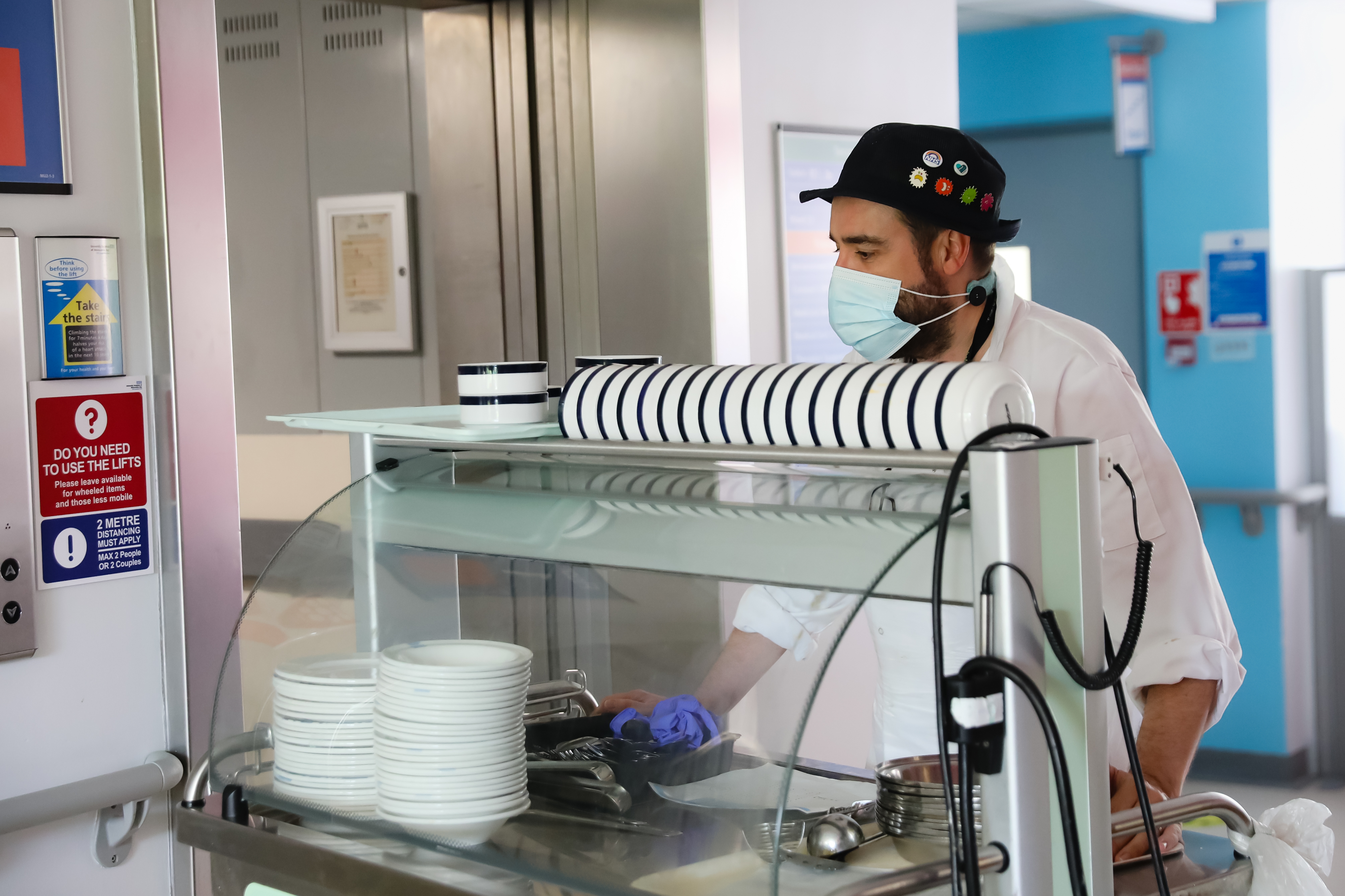 A member of the Morecambe Bay NHS Catering team pushing a food trolley