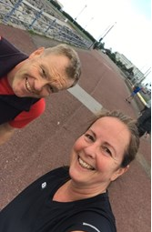 Dr Phil Batty and wife Joann smiling to camera during a walk on Morecambe Promenade.