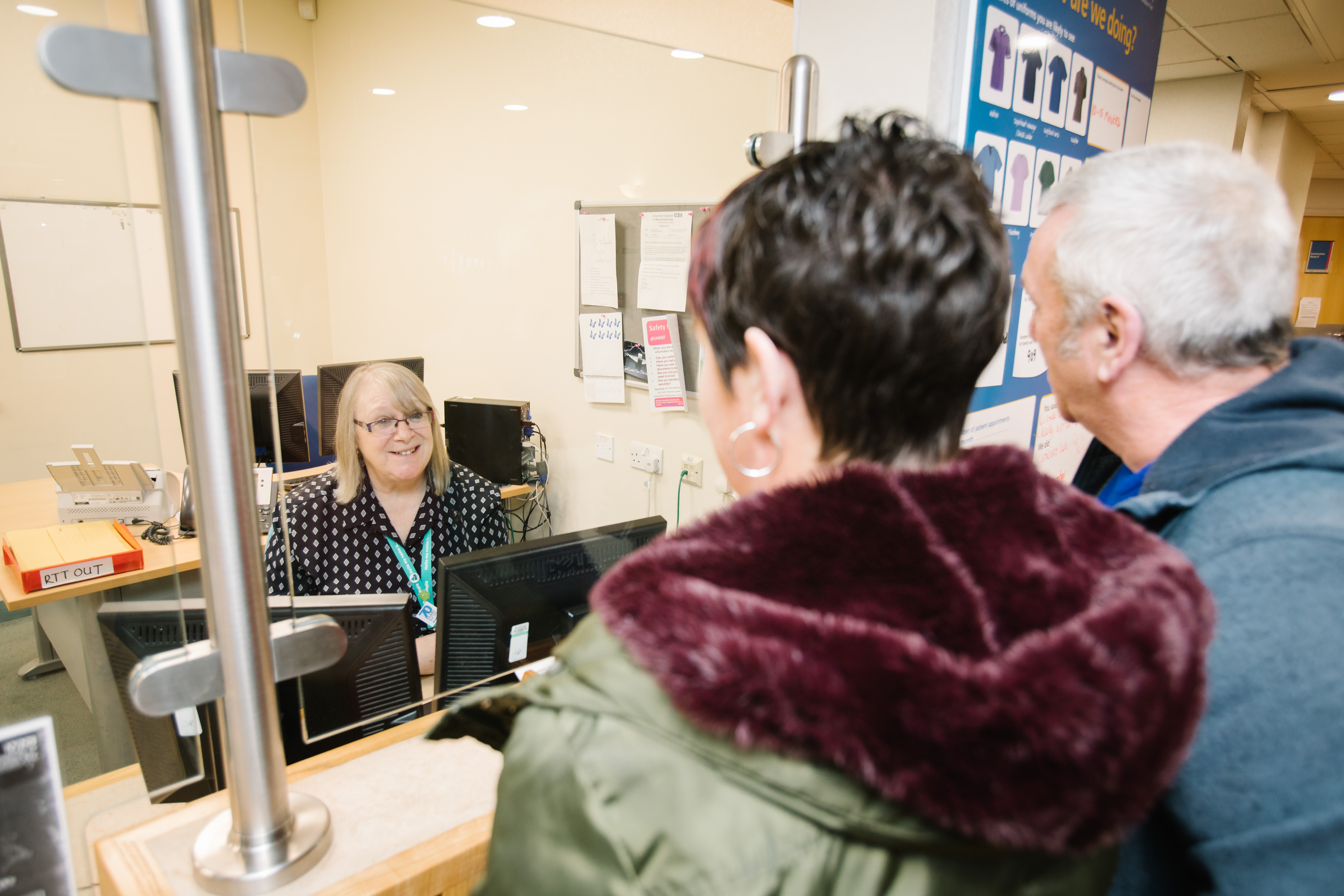 Patients being greeted by receptionist at the outpatients department