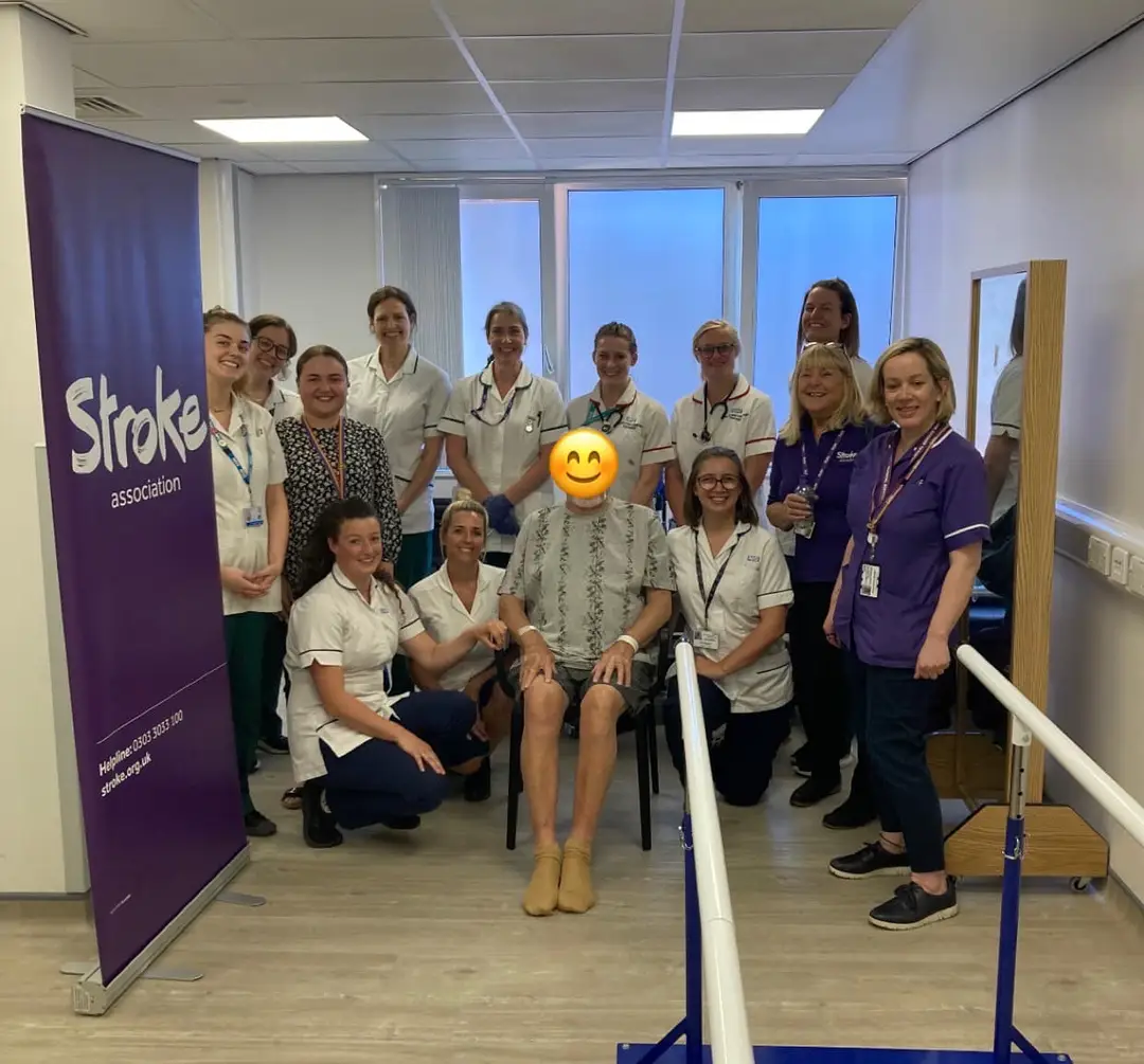 Group photo of the stroke service colleagues with a patient