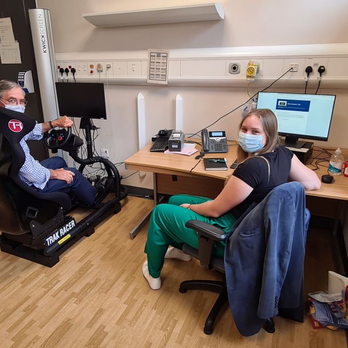 Mr Stewart in the chair with Susie Crayton Research intern.jpg