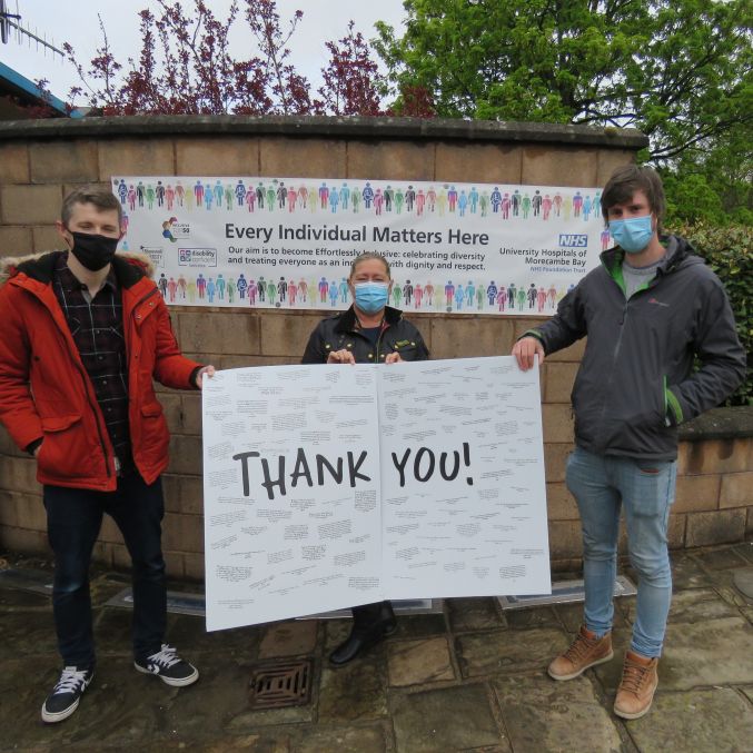 Sue Smith, OBE MSc BSc RN, Joint Deputy Chief Executive and Executive Chief Nurse, accepts a thank you card on behalf of the Bay Health and Care Partners from Assistant Pastor Jamie Haxby and volunteer Joshua Fox...jpg