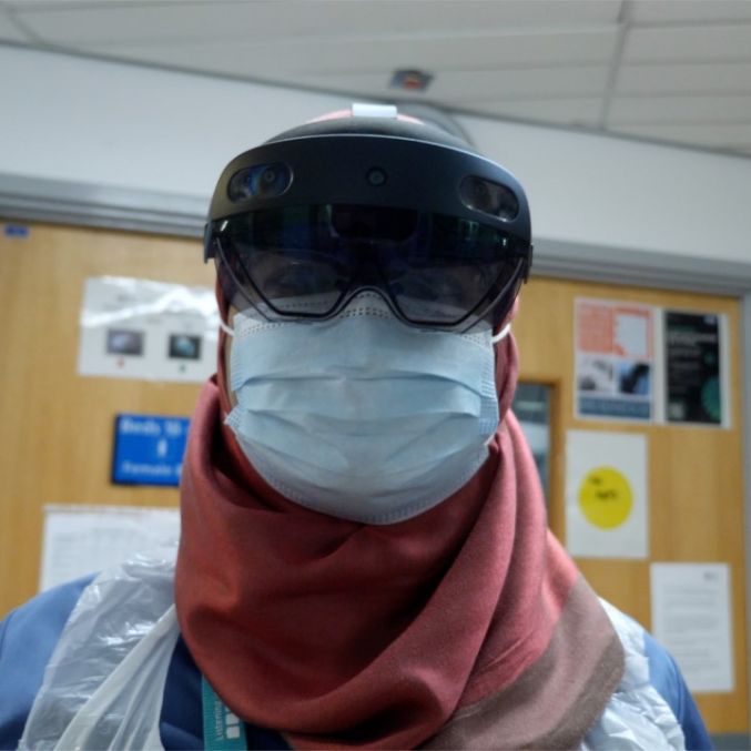 A member of staff wearing the HoloLens 2 headset.jpg